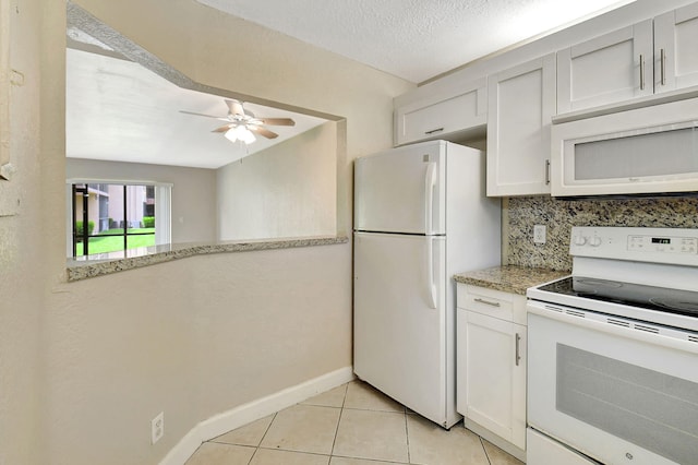 kitchen featuring a textured ceiling, white appliances, decorative backsplash, ceiling fan, and white cabinets