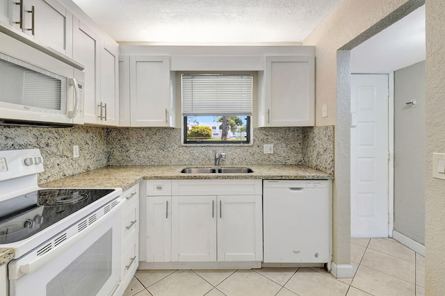 kitchen with white cabinetry, white appliances, sink, and a textured ceiling