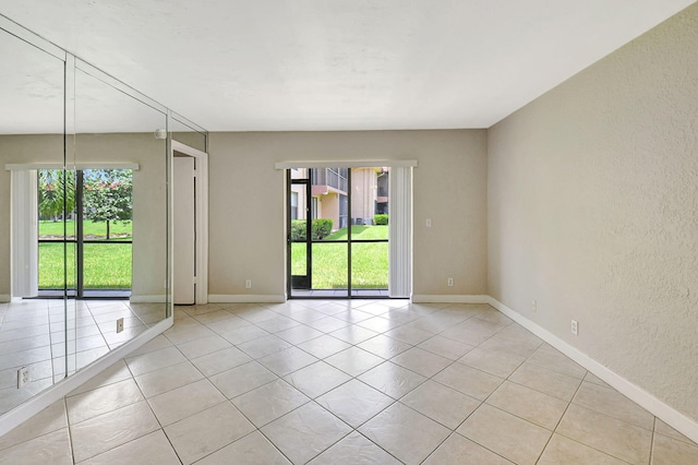 unfurnished room with light tile patterned floors