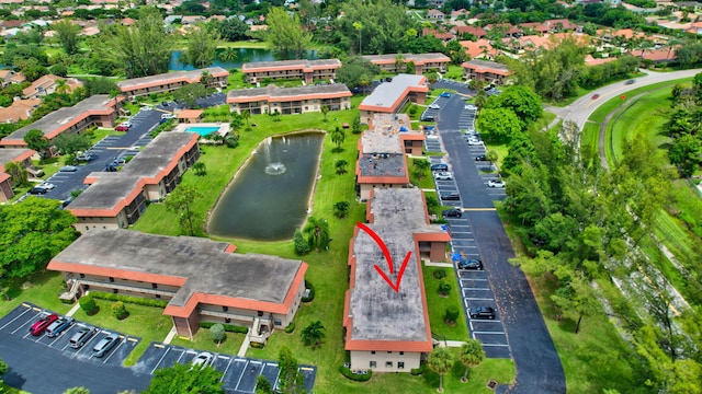 birds eye view of property with a water view