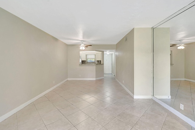 spare room featuring ceiling fan and light tile patterned floors