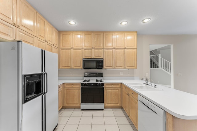 kitchen with kitchen peninsula, sink, light brown cabinets, and white appliances