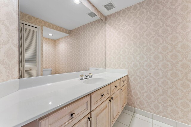 bathroom featuring vanity, toilet, and tile patterned floors