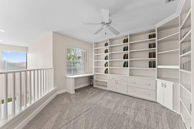 walk in closet featuring light carpet and ceiling fan