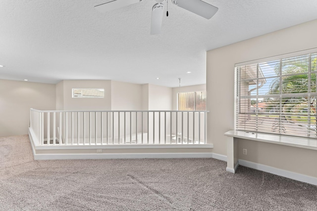 interior space featuring a textured ceiling and carpet