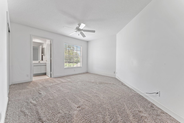 carpeted spare room with a textured ceiling and ceiling fan