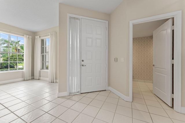 entryway featuring light tile patterned floors and baseboards