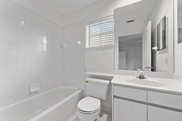 full bathroom featuring tiled shower / bath combo, vanity, toilet, and tile patterned floors