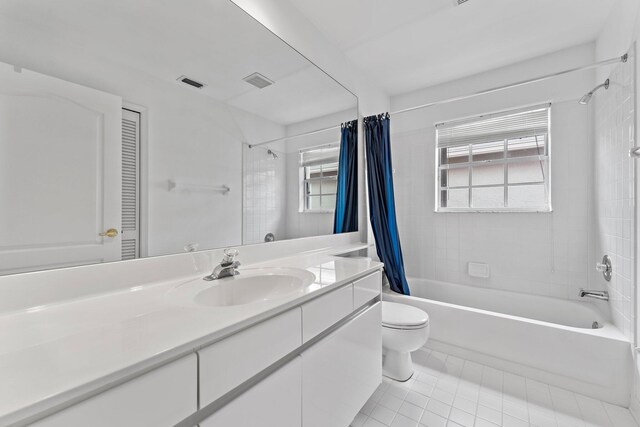 full bathroom with shower / bathtub combination with curtain, toilet, plenty of natural light, and vanity