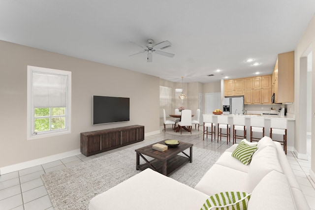 living room with ceiling fan and light tile patterned floors