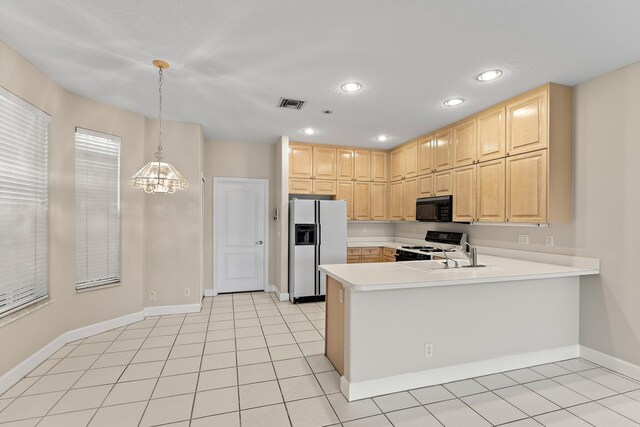 kitchen featuring light tile patterned floors, white appliances, a chandelier, sink, and kitchen peninsula