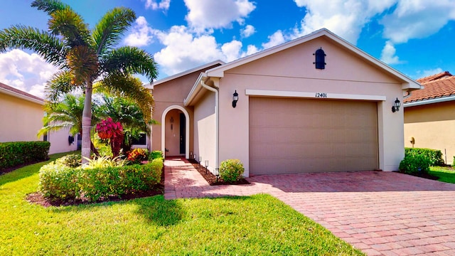 view of front of property with a front lawn and a garage