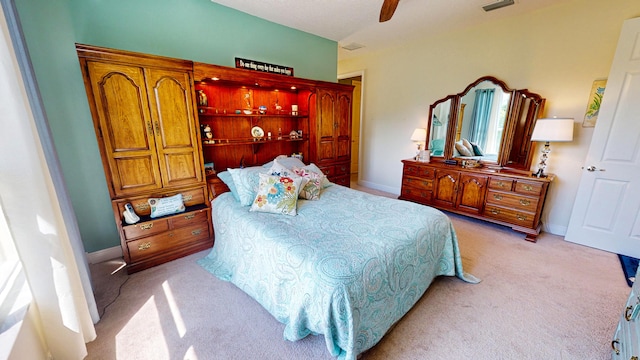 bedroom featuring light colored carpet and ceiling fan