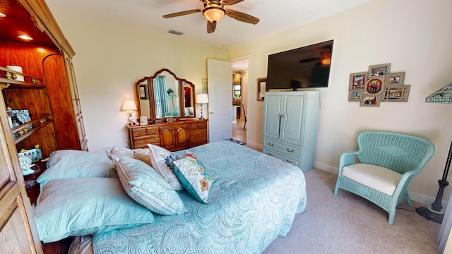 bedroom featuring light colored carpet and ceiling fan