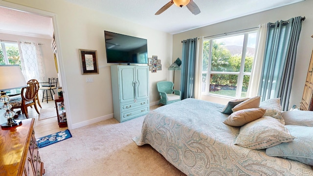 bedroom with light colored carpet and ceiling fan