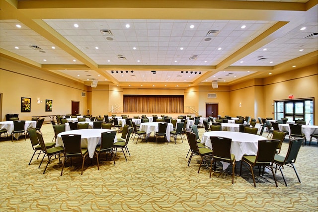 dining area featuring light carpet, coffered ceiling, and a high ceiling