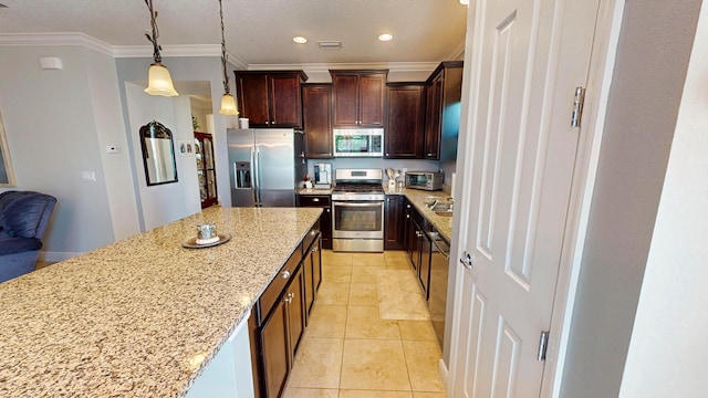 kitchen with hanging light fixtures, stainless steel appliances, light stone counters, crown molding, and a kitchen island