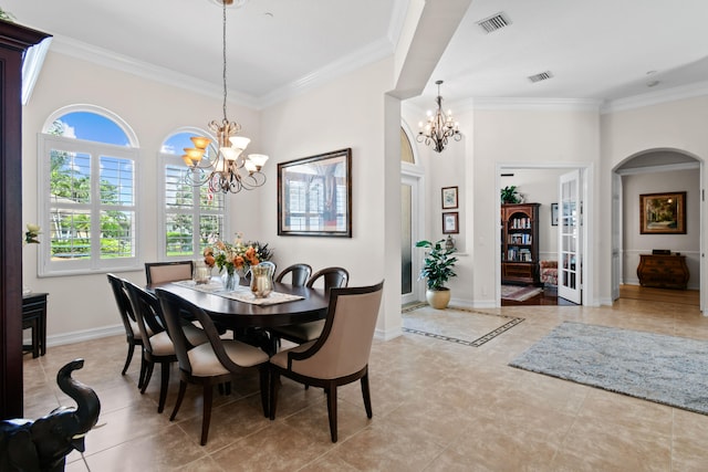 dining space with crown molding and an inviting chandelier