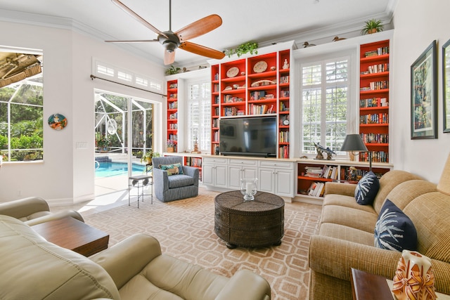 living room with ceiling fan and crown molding