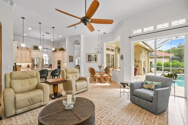 living room with ceiling fan, light tile patterned floors, and ornamental molding