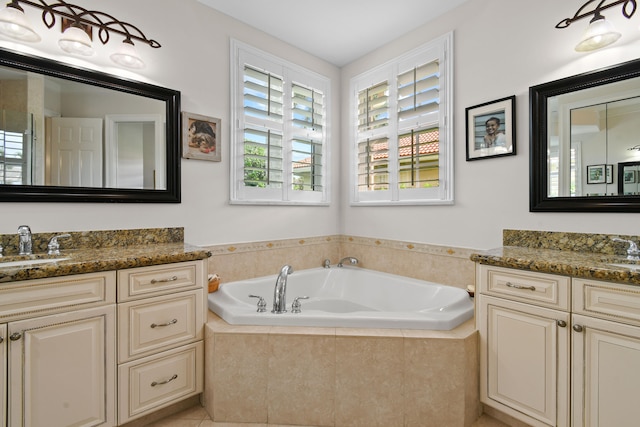 bathroom featuring vanity and a relaxing tiled tub