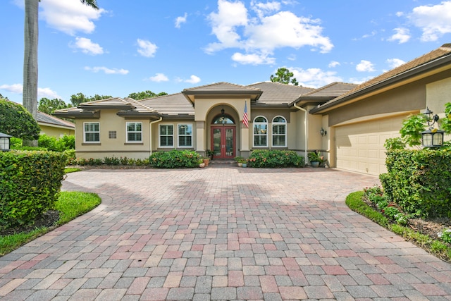 view of front of property featuring french doors and a garage