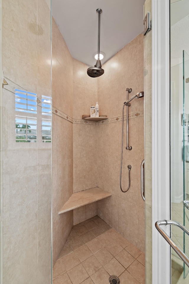 bathroom with walk in shower and tile patterned flooring