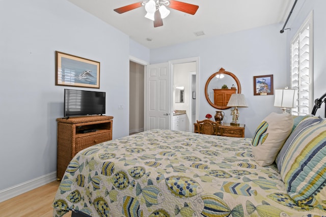 bedroom with ensuite bathroom, ceiling fan, and light hardwood / wood-style floors