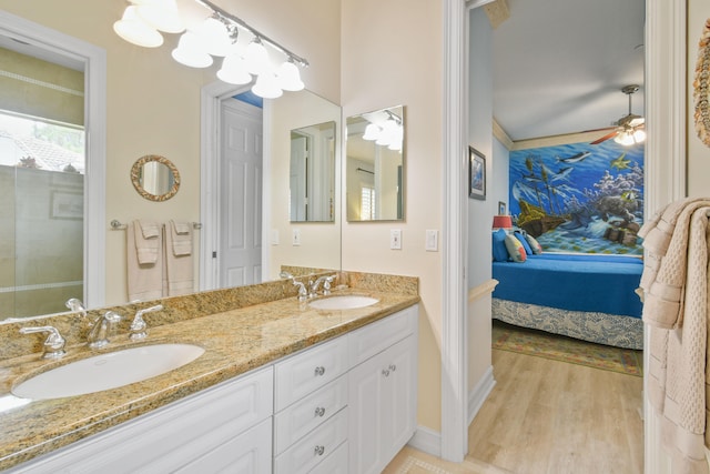 bathroom featuring vanity, hardwood / wood-style flooring, ceiling fan, and crown molding