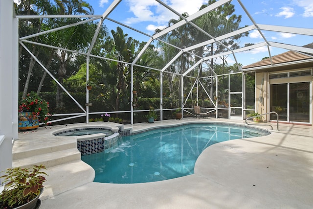 view of swimming pool with a lanai, a patio, and an in ground hot tub