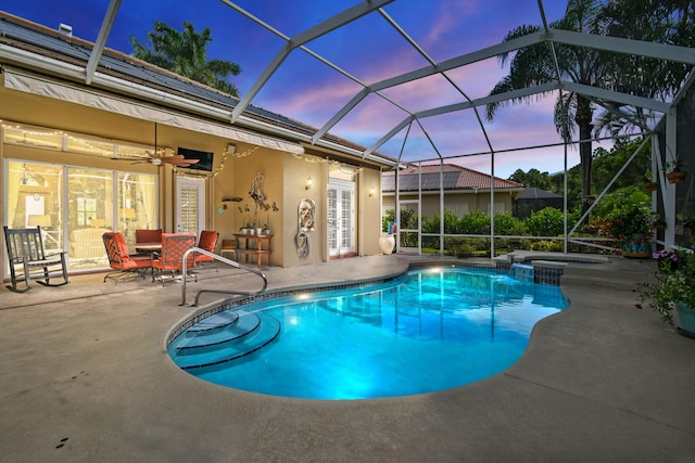 view of swimming pool featuring a patio, ceiling fan, glass enclosure, and an in ground hot tub