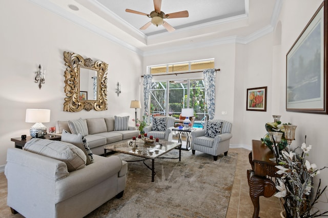 living room featuring a raised ceiling, ceiling fan, and crown molding