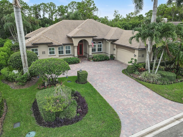 view of front of home featuring a garage and a front lawn