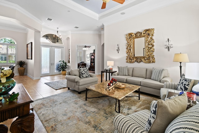 tiled living room featuring ceiling fan, french doors, and crown molding