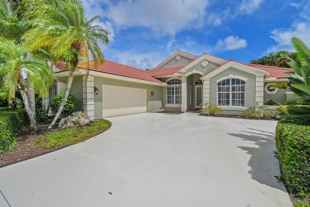 mediterranean / spanish-style home featuring a garage