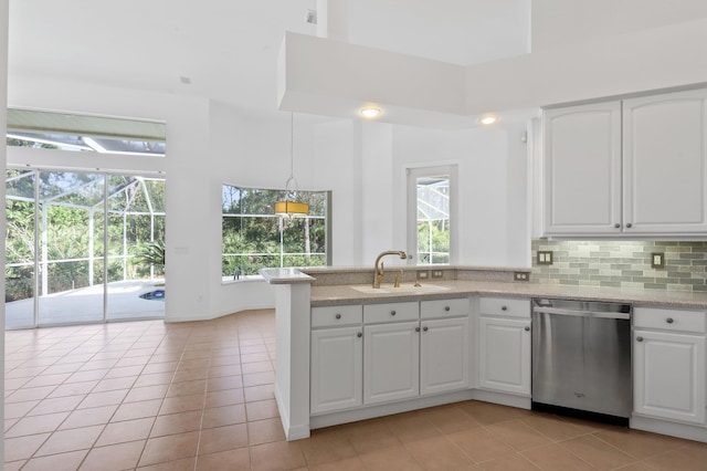 kitchen featuring dishwasher, decorative light fixtures, white cabinets, and sink