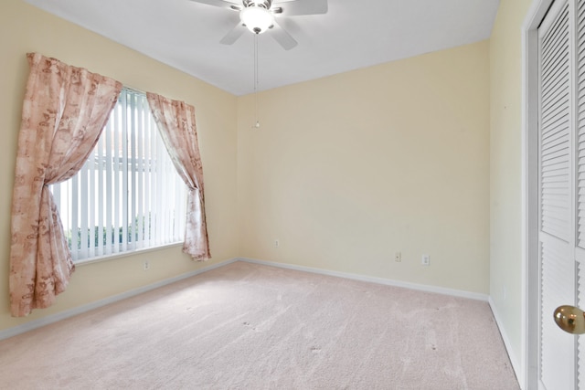 empty room with light carpet and ceiling fan