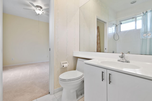 bathroom featuring vanity, a shower, tile patterned flooring, ceiling fan, and toilet