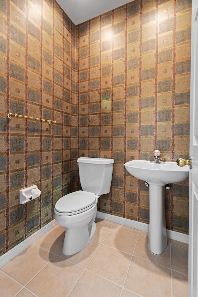 bathroom with tile patterned flooring and toilet