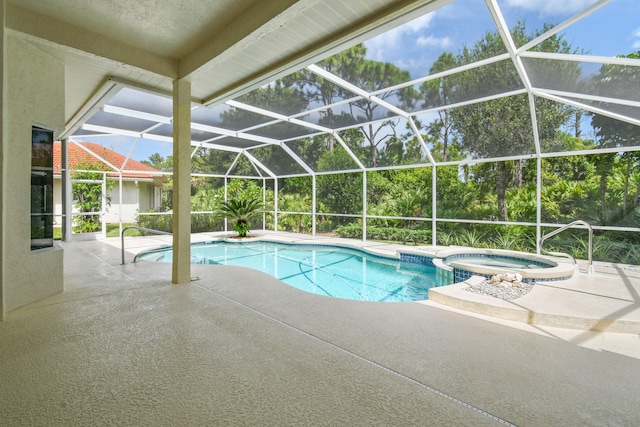 view of pool with a lanai, an in ground hot tub, and a patio