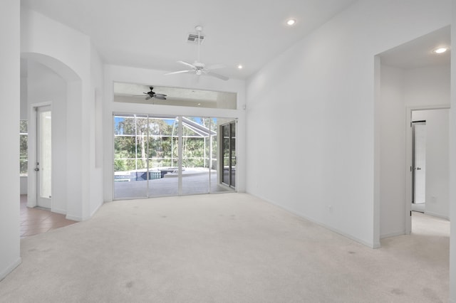 unfurnished living room with ceiling fan and light carpet