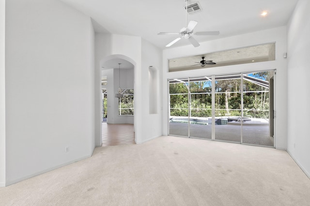 unfurnished room featuring light colored carpet and ceiling fan