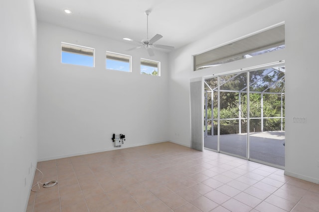 tiled empty room with ceiling fan