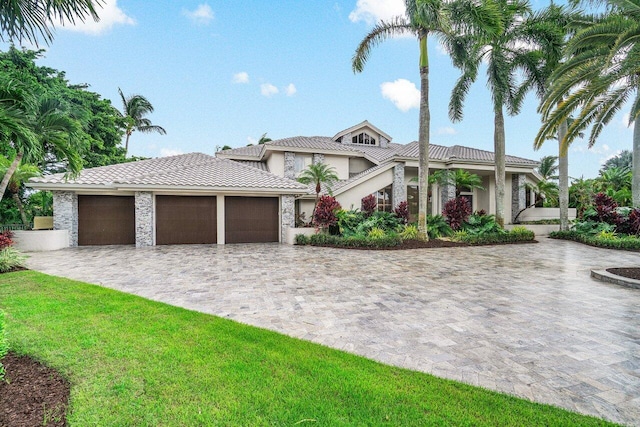 mediterranean / spanish-style house with a garage and a front yard