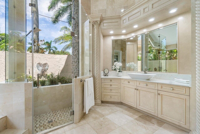 bathroom with a shower with door and vanity