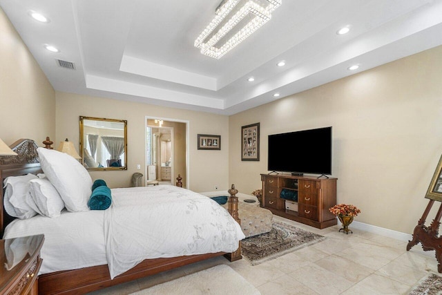 bedroom with a tray ceiling and a notable chandelier