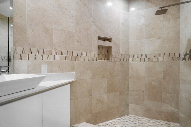 bathroom with vanity and tiled shower