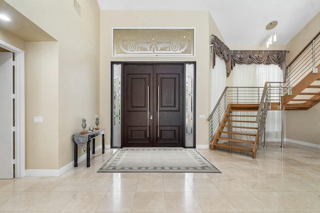 foyer entrance with light tile patterned flooring