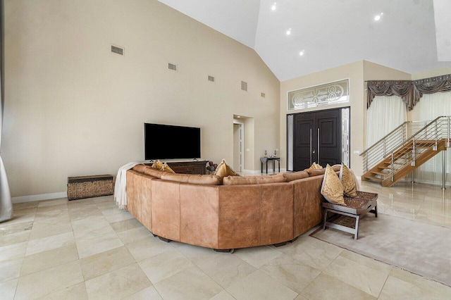 living room featuring high vaulted ceiling