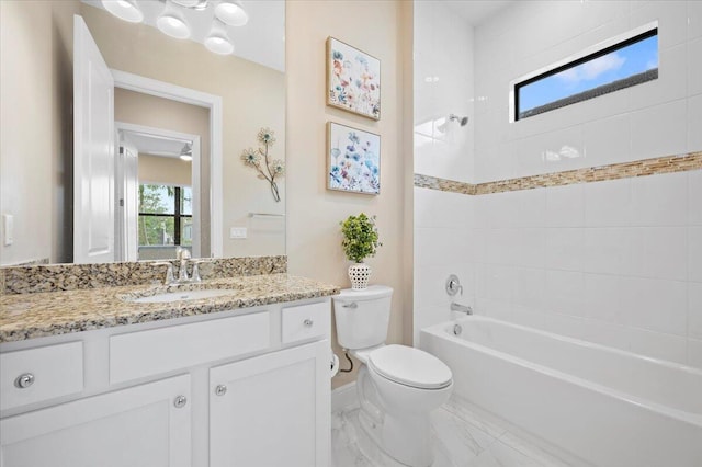 full bathroom featuring vanity, toilet, and tiled shower / bath